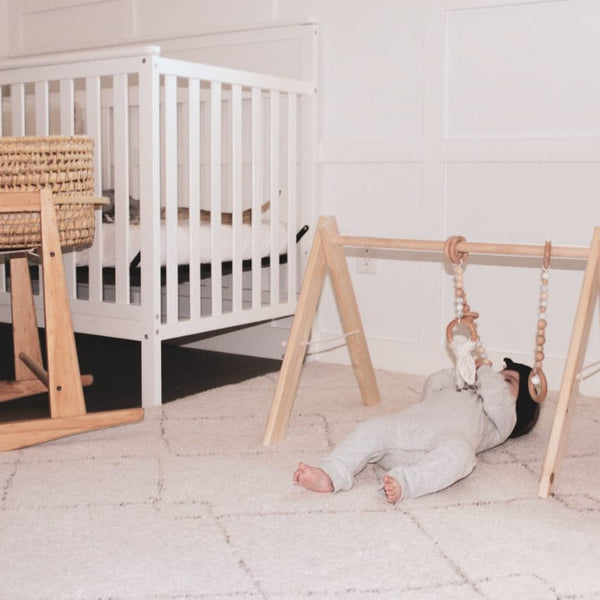 Sensory Play with a Wooden Baby Play Gym